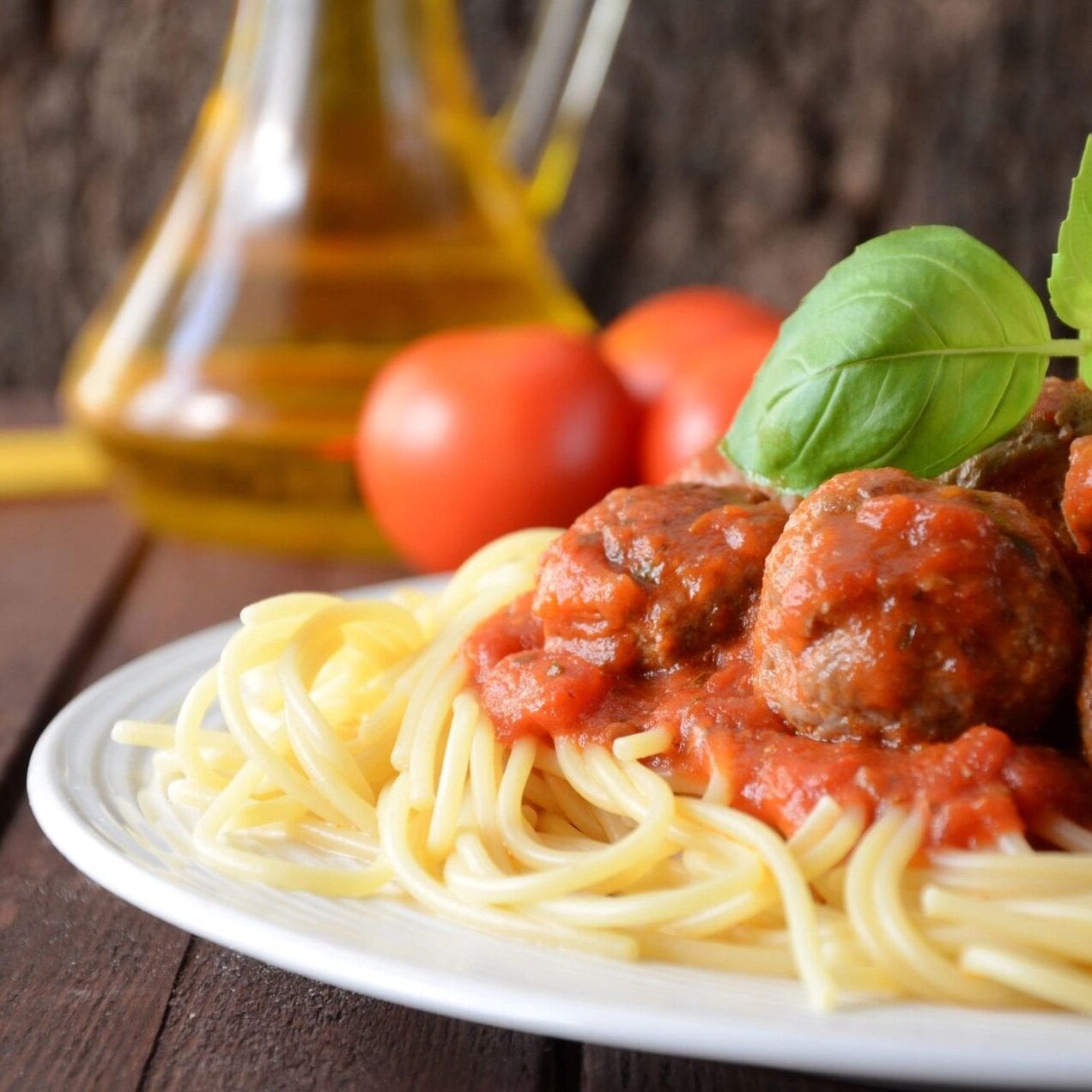 A plate of spaghetti and meatballs on top of a table.